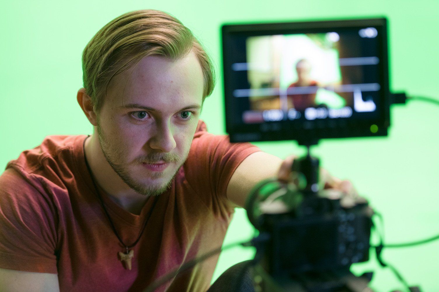 KCAI student Nick Sparger prepares their camera in the KCAI Filmmaking Studio