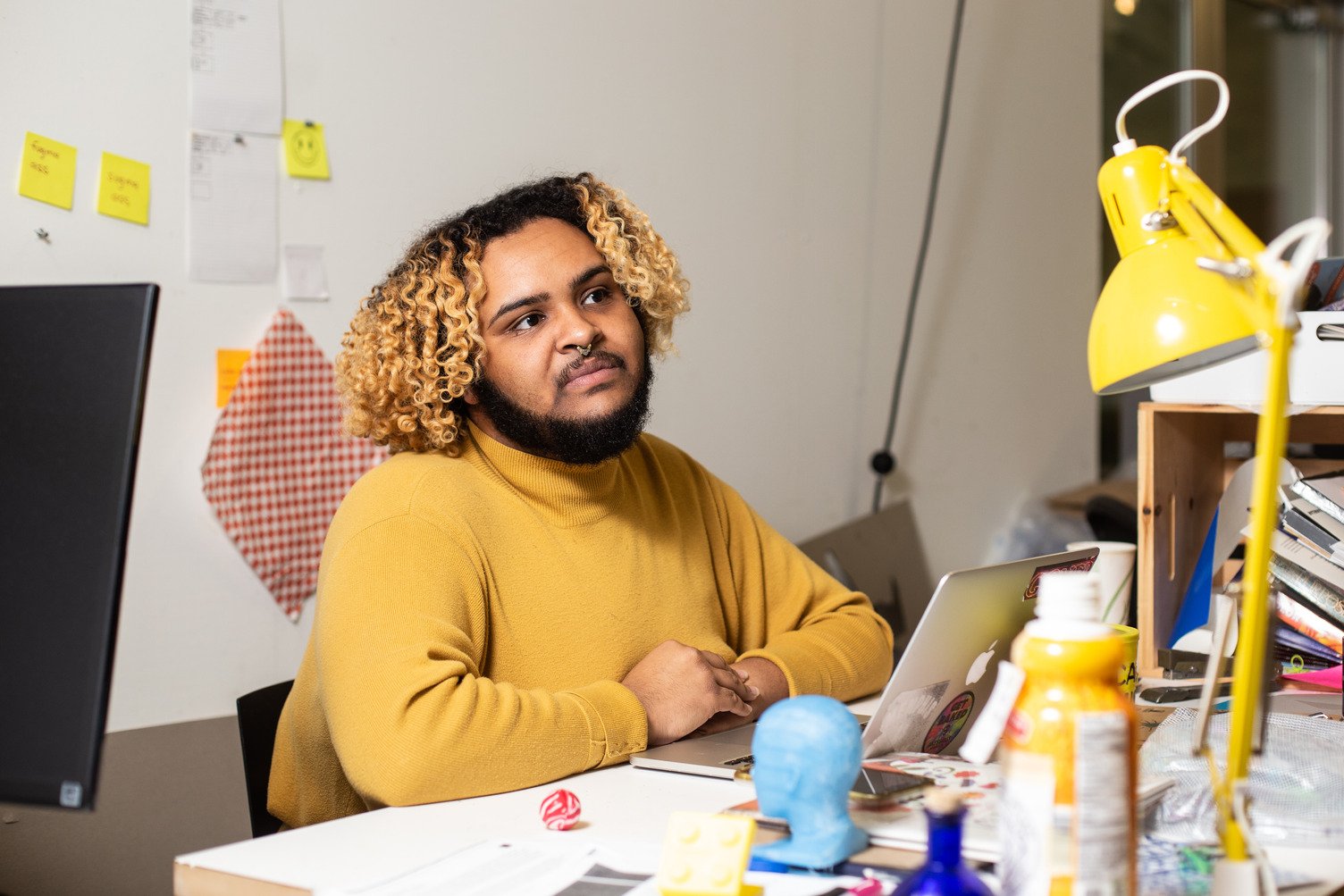 KCAI Graphic Design student receives instruction in their personal space within the Junius B. Irving Graphic Design studio